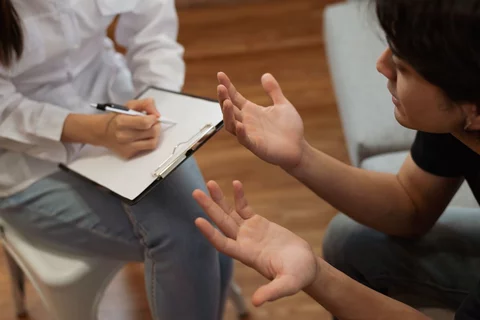 UCLA Medical School Psychologist Psychiatrist With Clipboard Talking to Mental Health Patient