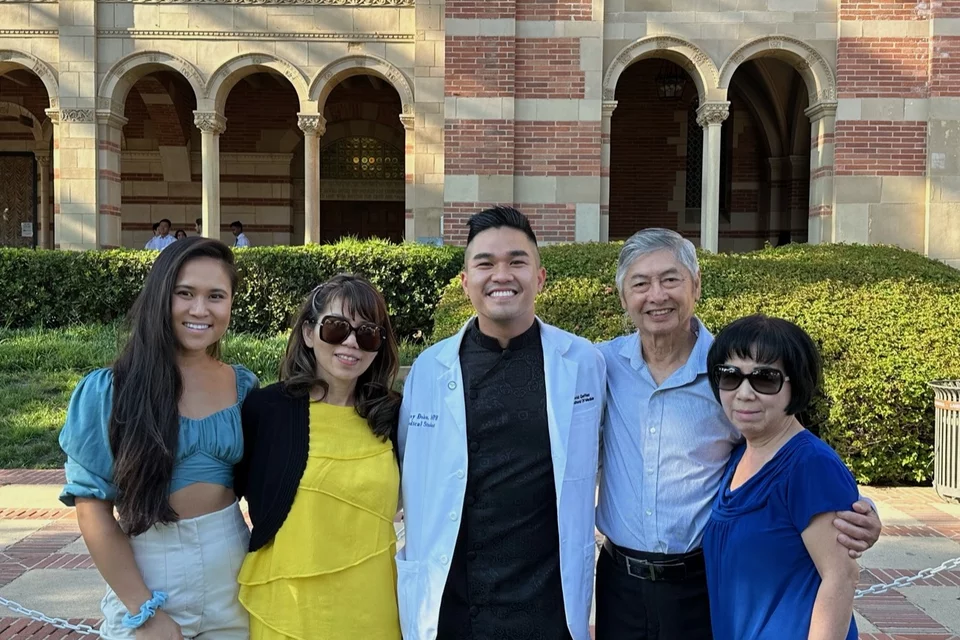 First-general medical student Danny Đoàn, pictured with his family in front of a UCLA academic building.