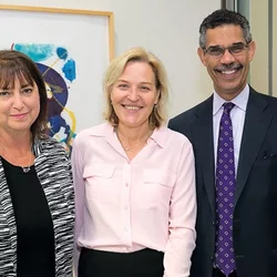 two female and male professionals standing