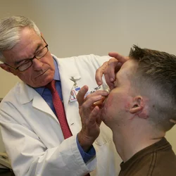 Dr. Timothy Miller treats Cpl. Aaron P. Mankin. 