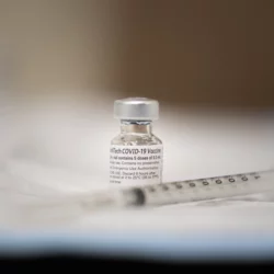 COVID-19 vaccine vial and needle