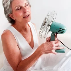 Woman with fan blowing