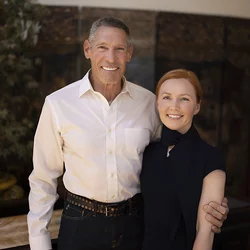 Gary Michelson, left, and Aya Michelson stand with arms around each other