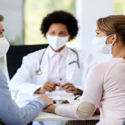three adults wearing masks