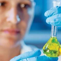 Female scientist holding beaker